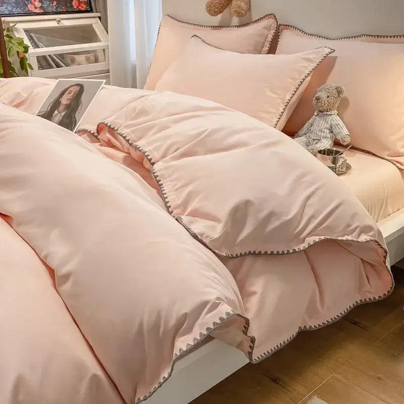 Soft blush pink bedding set with delicate gray zigzag stitching and decorbites cozy shell edges for bedroom use