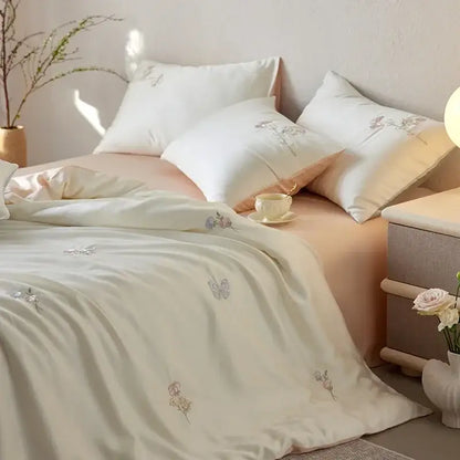 Cream-colored satin comforter set with delicate cartoon embroidery floral and butterfly motifs by decorbites