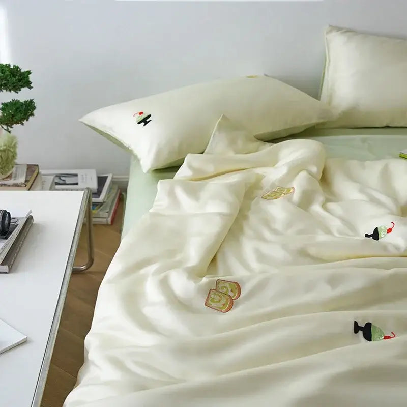 Cream and green satin comforter set with decorbites cartoon embroidery featuring vibrant pastel dessert motifs