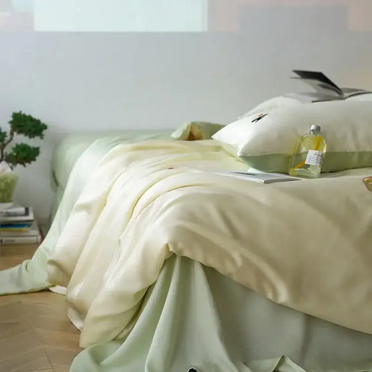 Soft cream satin comforter set with cartoon embroidery and subtle green accents from decorbites cartoon embroidery collection