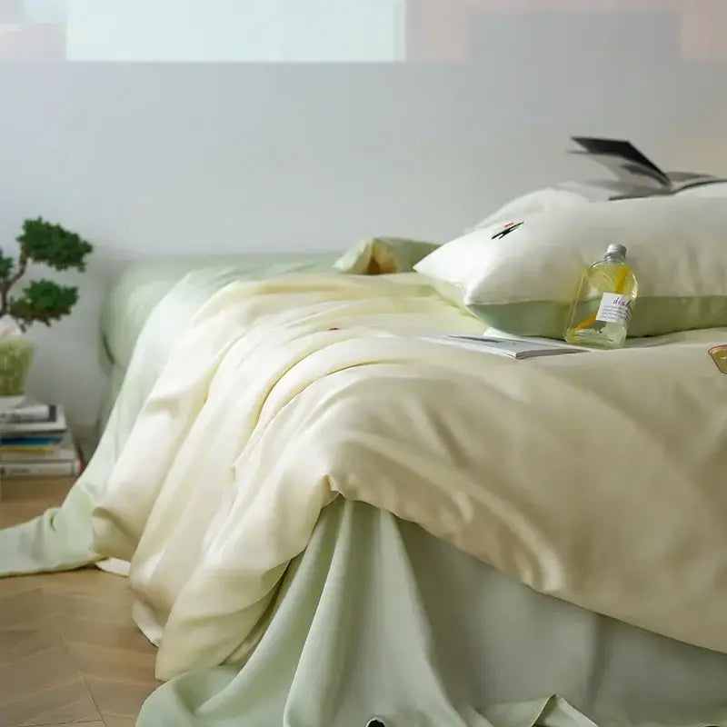 Soft cream satin comforter set with cartoon embroidery and subtle green accents from decorbites cartoon embroidery collection