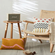 Cream and green embroidered cushion cover with cream-colored marshall speaker featuring green grille and silver logo