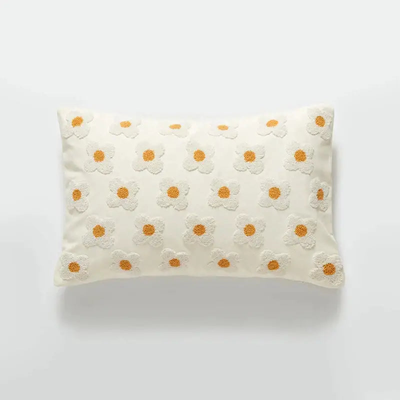 Cream-colored embroidered cushion cover with white daisies and orange centers for living room decor