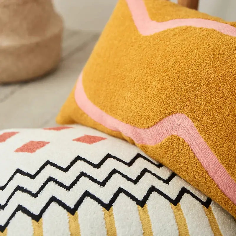 Mustard yellow textured embroidered cushion cover with wavy pink border for living room decor