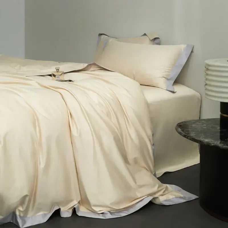 Cream-colored satin duvet cover bedding set with subtle gray trim in egyptian cotton hotel style bedroom collection