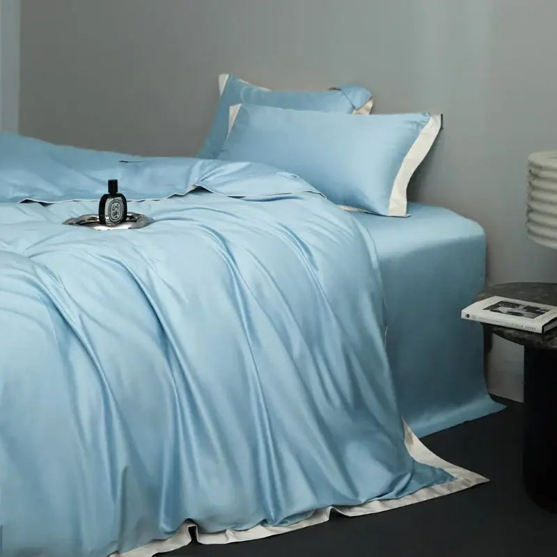 Light blue satin bedding set with white piping in a cream and lavender egyptian cotton hotel style bedroom