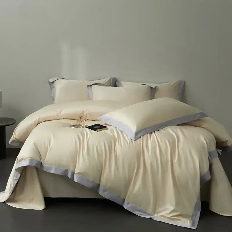 Cream-colored satin duvet cover set with soft gray piping trim in egyptian cotton hotel style bedding set