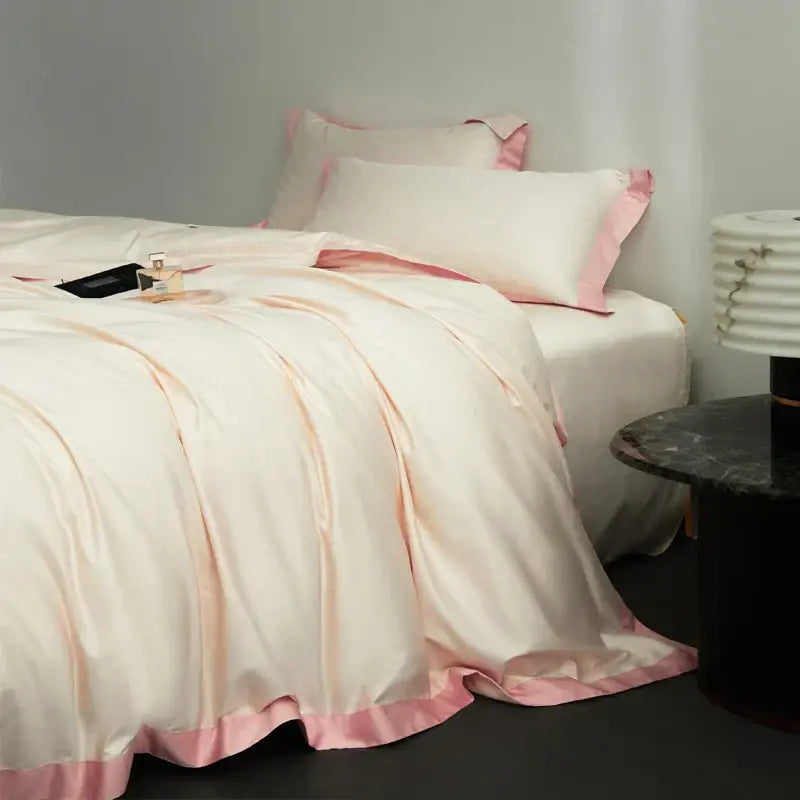 Cream-colored satin duvet cover with pink piping in a cream and lavender egyptian cotton hotel style bedding set