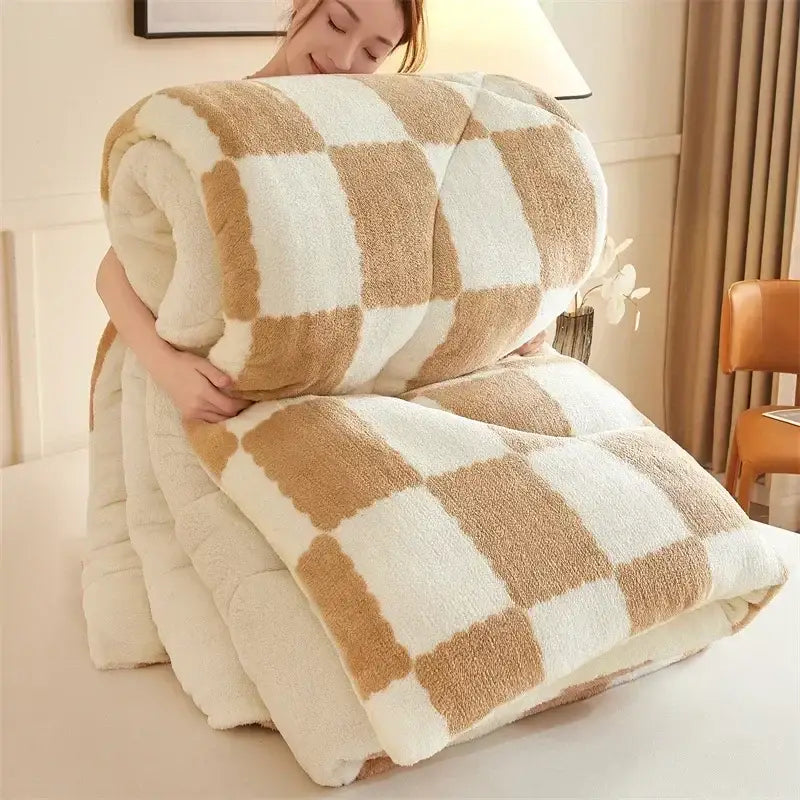 A cream and tan cozy checkerboard cashmere weighted blanket with plush fleece and soft textured surface