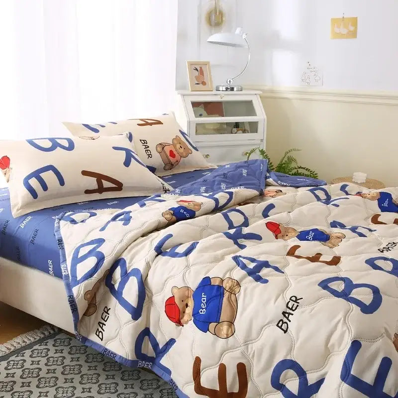 Cream bear quilt and pillowcase set with cream background, blue and brown bear lettering, red hat bears bedding set