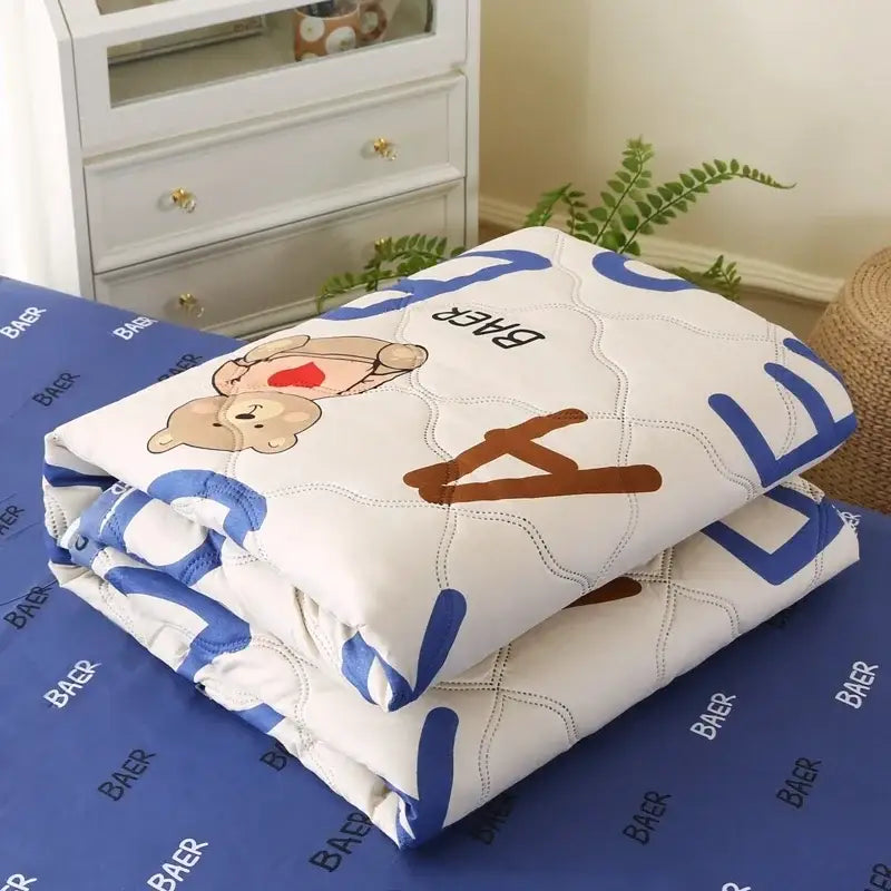 Cream bear quilt and pillowcase set in white with blue and brown bear designs for a comfortable night’s sleep