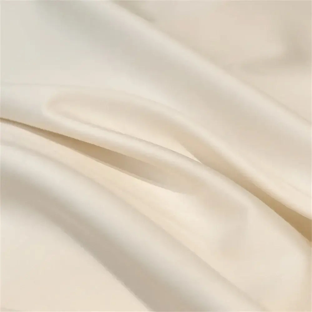 Cream and black egyptian cotton bedding set featuring smooth cream-colored satin fabric with soft folds for bedroom satin linens