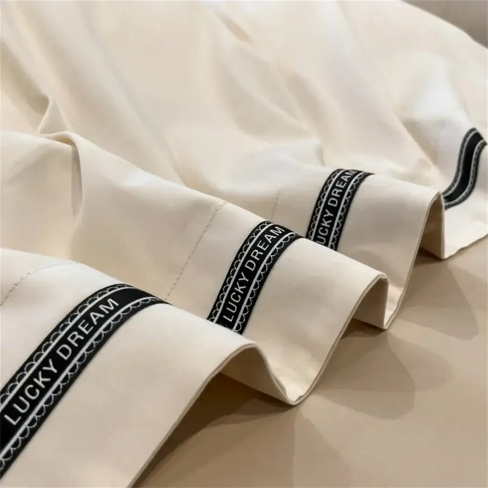 Cream and black egyptian cotton bedding set with cream pillowcases featuring black embroidered lucky dream bands