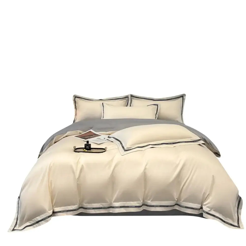 Cream and black egyptian cotton bedding set featuring satin linens with cream satin and black piping trim