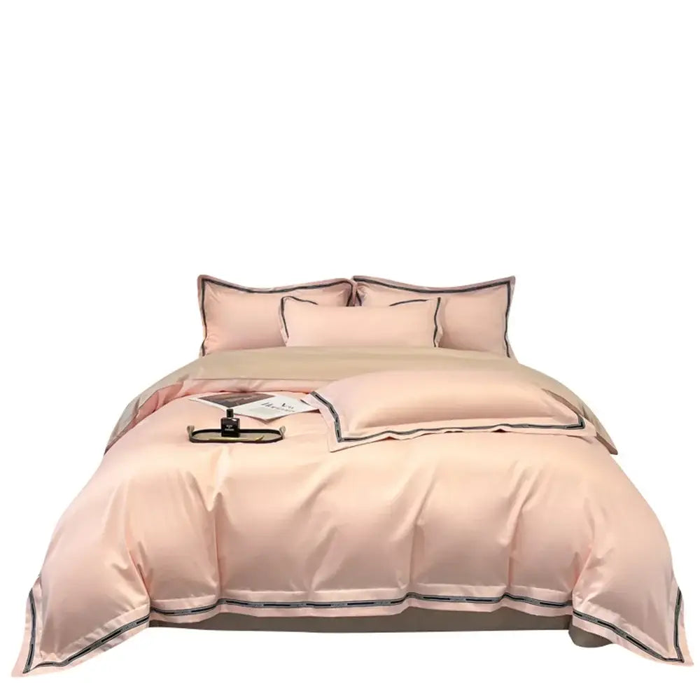 A soft blush pink egyptian cotton bedding set with black trim in an elegant cream and black satin design