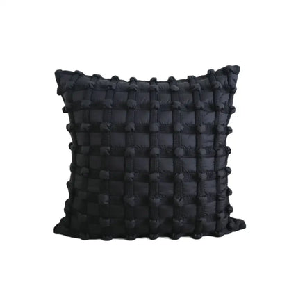 Black cushion cover with textured woven bubble plaid pattern and raised pom-poms for decorbites bubble plaid decor