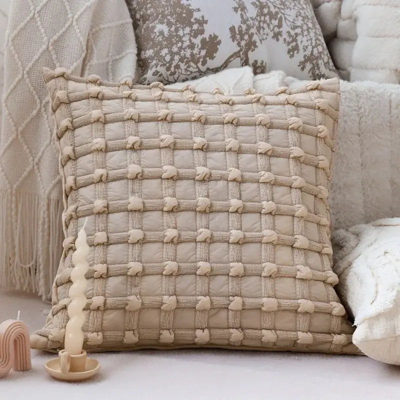 Cream bubble plaid cushion cover featuring a beige quilted throw pillow with textured woven pattern and knotted detailing