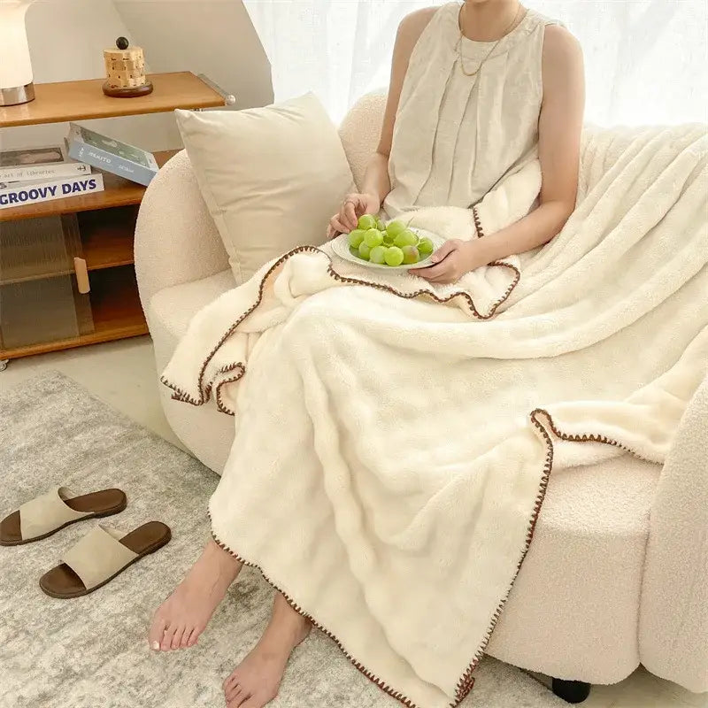 Cream-colored bubble velvet woolen sofa blanket with textured surface and decorative brown stitched trim for living room decorbites bubble velvet