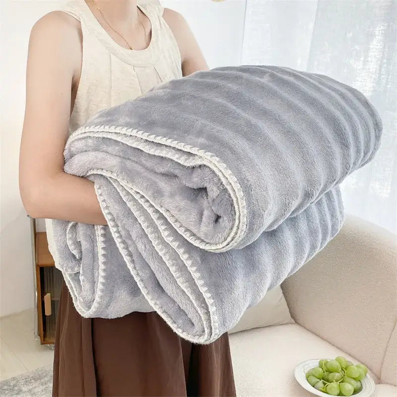 A plush light gray decorbites bubble velvet woolen sofa blanket with white stitched trim for living room decor