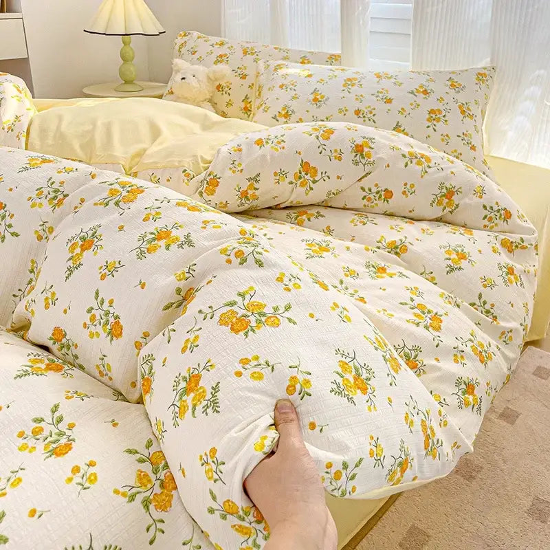 A soft off-white duvet cover with a delicate yellow and green floral pattern from decorbites cartoon pattern cotton bedding set