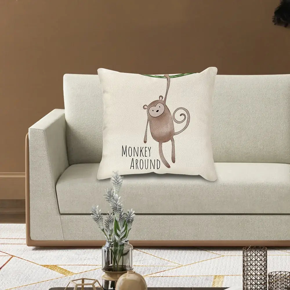 Cream cartoon animal linen pillowcase with a beige cushion featuring a brown monkey and the text monkey around for decorbites