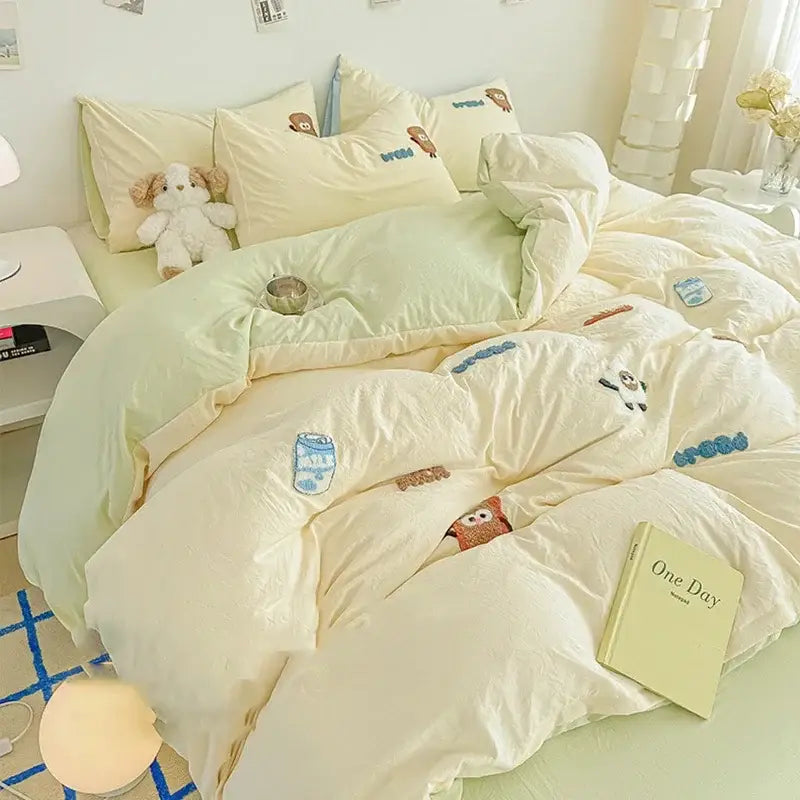 Cream cartoon embroidery jacquard comforter set featuring cream quilted duvet with plush texture and pastel blue brown patches