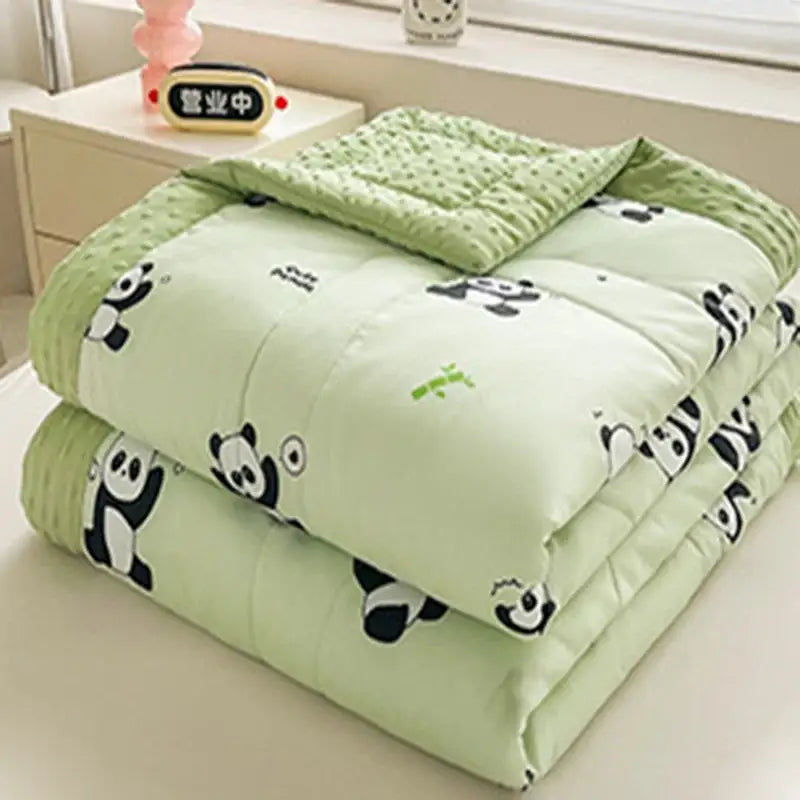 A soft light green cream cartoon pattern summer quilt featuring playful black and white pandas with bamboo motifs