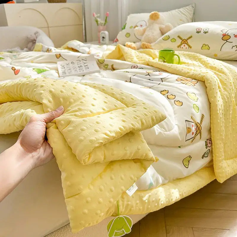 Soft yellow cream cartoon pattern summer quilt with textured dots and playful decorbites cartoon pattern underside