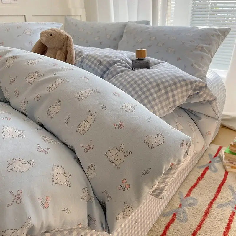 Light blue bunny-themed decorbites cartoon printed cotton bedding set with soft textured fabric and pink floral accents