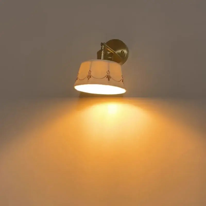Cream ceramic led wall lamps with brass finish and cream fabric shade with red embroidery for bedroom decorbites ceramic led