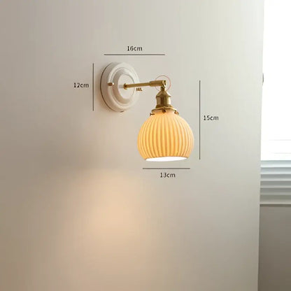 Cream ceramic led wall light with copper arm featuring a cream ribbed glass lamp and brass-finished metal mounting plate decorbites ceramic led