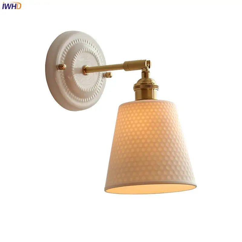 Cream ceramic led wall light with copper arm featuring a hammered glass shade and brass decorbites ceramic led finish