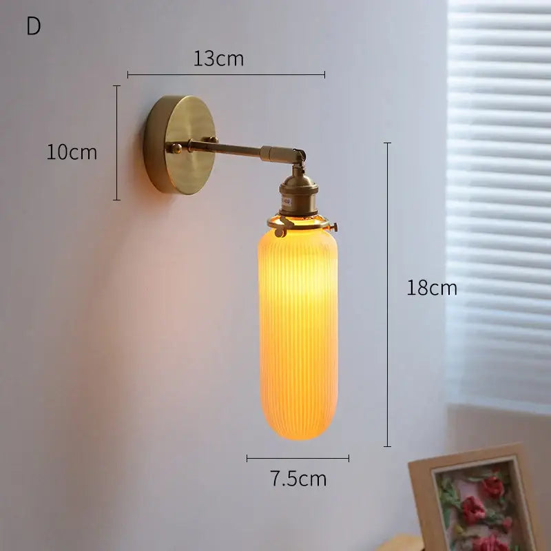 Vintage-style cream ceramic led wall light with copper arm and warm amber ribbed glass shade for bedroom decorbites ceramic led