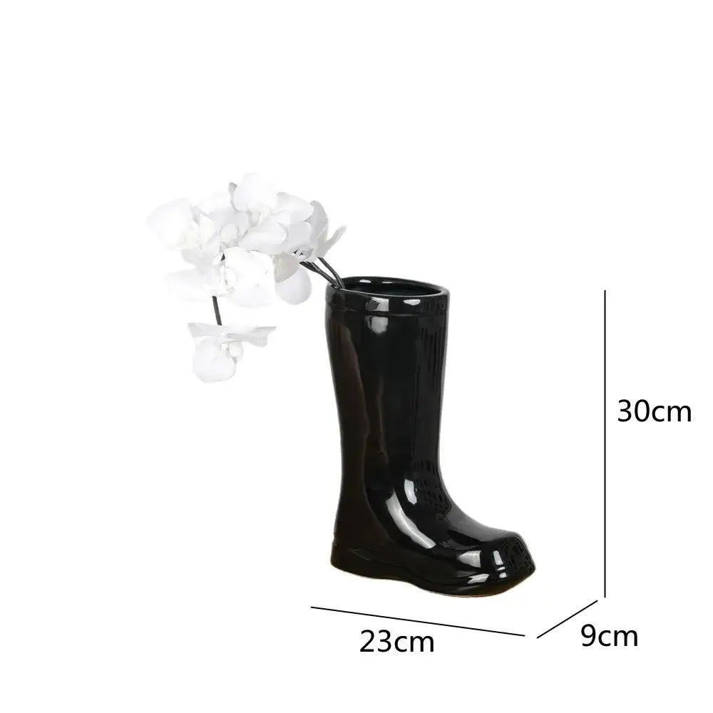 Black glossy ceramic shoe vase by decorbites holding white orchids for elegant living room decorbites ceramic vase