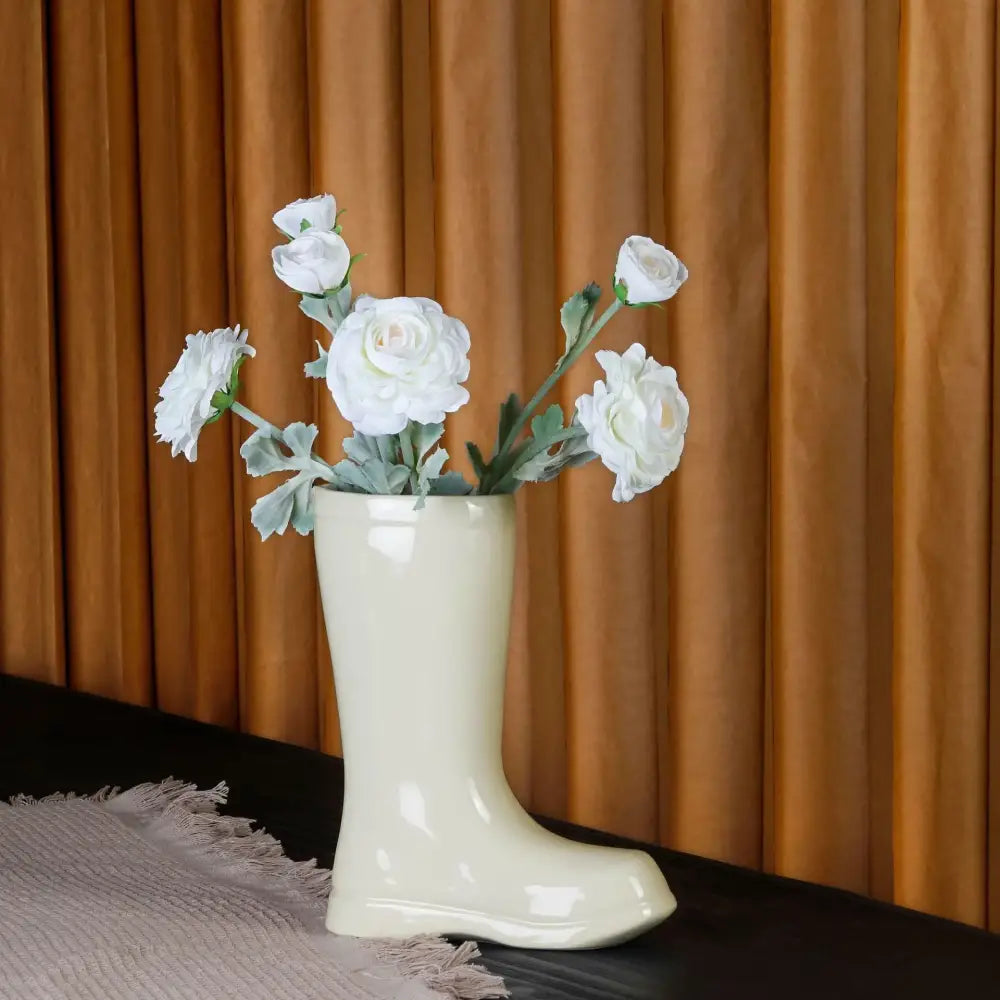 Cream ceramic shoe vase by decorbites holding white flowers for living room flower decor