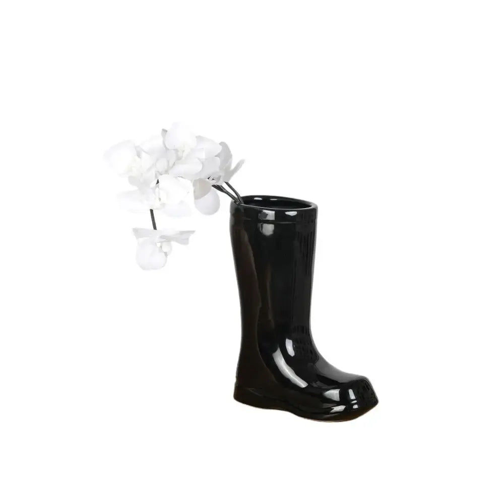 Shiny black decorbites ceramic shoe vase holding white orchids for stylish living room flower decor