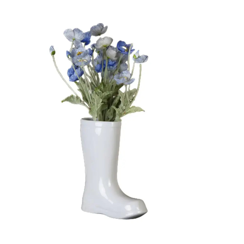 Cream decorbites ceramic shoe vase in white ceramic shaped like a boot holding blue and white artificial poppies decor