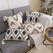 Set of three cream and charcoal grey geometric tufted cushion covers with textured fabric and tassels for living room decorbites decor