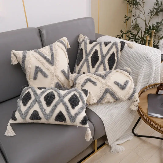 Set of three cream and charcoal grey geometric tufted cushion covers with textured fabric and tassels for living room decorbites decor