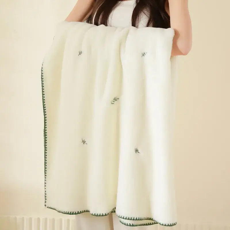 Cream cherry velvet embroidered blanket in cream with green tree motifs and zigzag border, a baby velvet embroidered throw