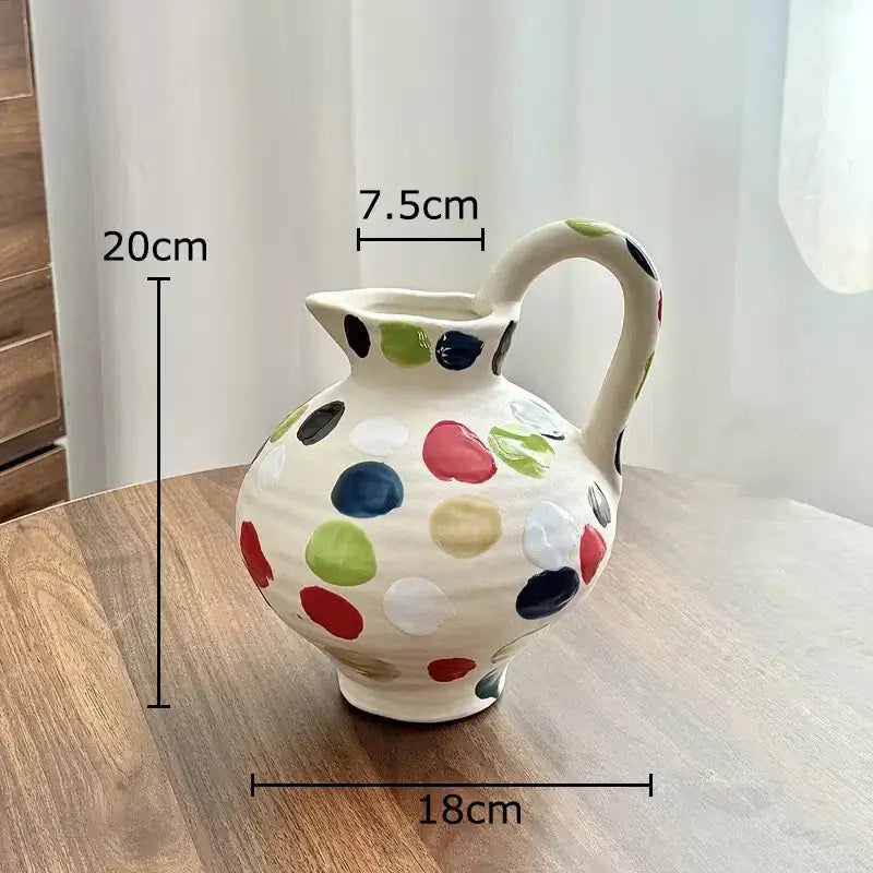A cream colorful dot ceramic pitcher vase adorned with hand-painted multicolor dots for kitchen floral decor