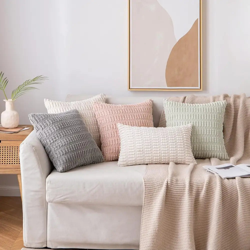 A collection of cream decorbites corduroy striped throw pillow covers in soft pastel and neutral tones for living room decor