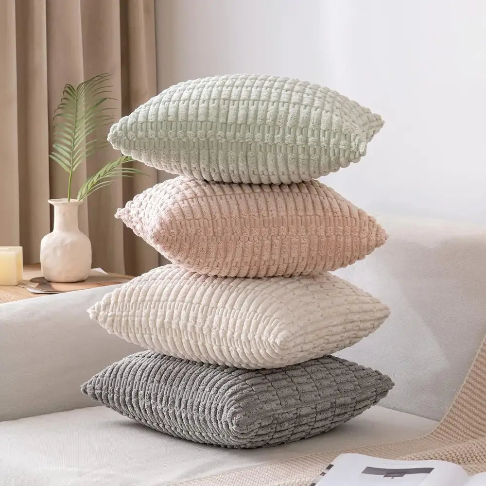 Stack of four cream decorbites corduroy striped throw pillow covers in soft pastel shades for living room decor