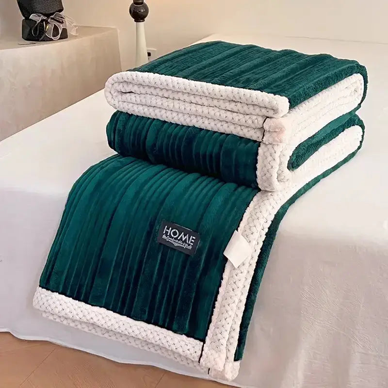 Deep green plush blanket with white knitted border and ribbed texture featuring black home brand label for cozy faux rabbit decorbites