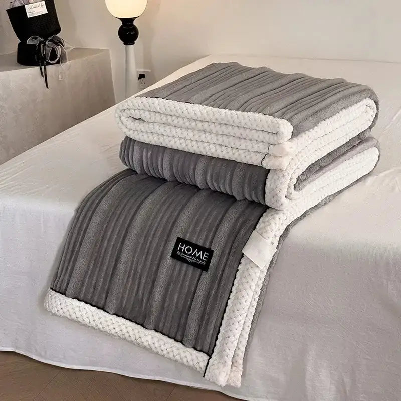 Gray and white ribbed fleece throw blanket with textured knit border and black piping edge from decorbites cozy faux plush blanket