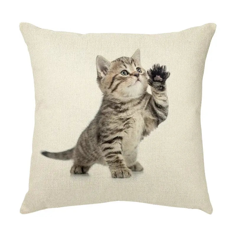 Beige linen throw pillow with a cute cat face decorative print of a tabby kitten raising a paw for living room use