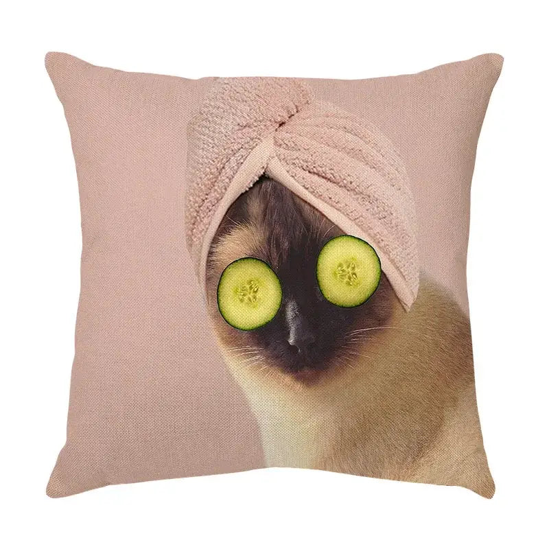 Cream soft pink linen throw pillow with a cute cat face decorative print of a siamese cat wearing cucumber slices and towel