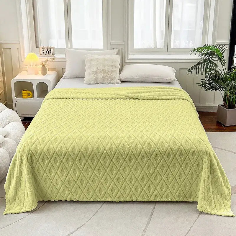 A soft light green quilted throw blanket with diamond jacquard coral fleece texture for bedroom bedding