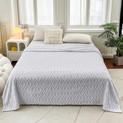 Soft light gray quilted throw blanket with diamond jacquard coral fleece pattern and plush texture for bedroom use