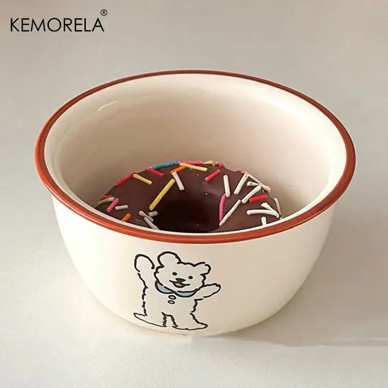 White ceramic carton ceramic soup bowl with brown rim and waving bear illustration holding a chocolate donut with sprinkles